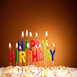 happy-birthday-lit-candles-closeup-23856175.jpg