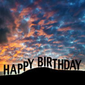 happy-birthday-sign-silhouetted-hillside-dramatic-sunset-sunrise-clouds-38520280.jpg