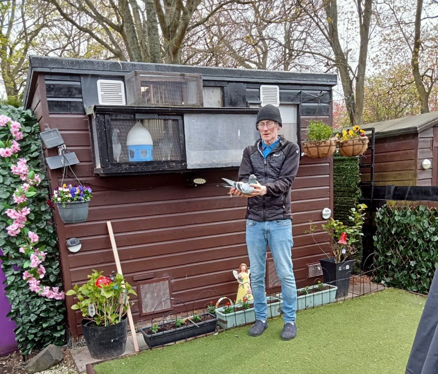 Paul Cameron holding his winner outside his small loft.JPG